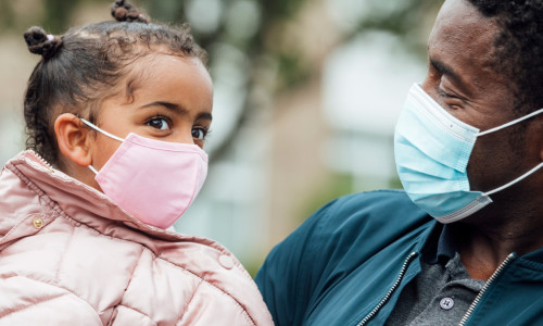 Father and daughter with masks on